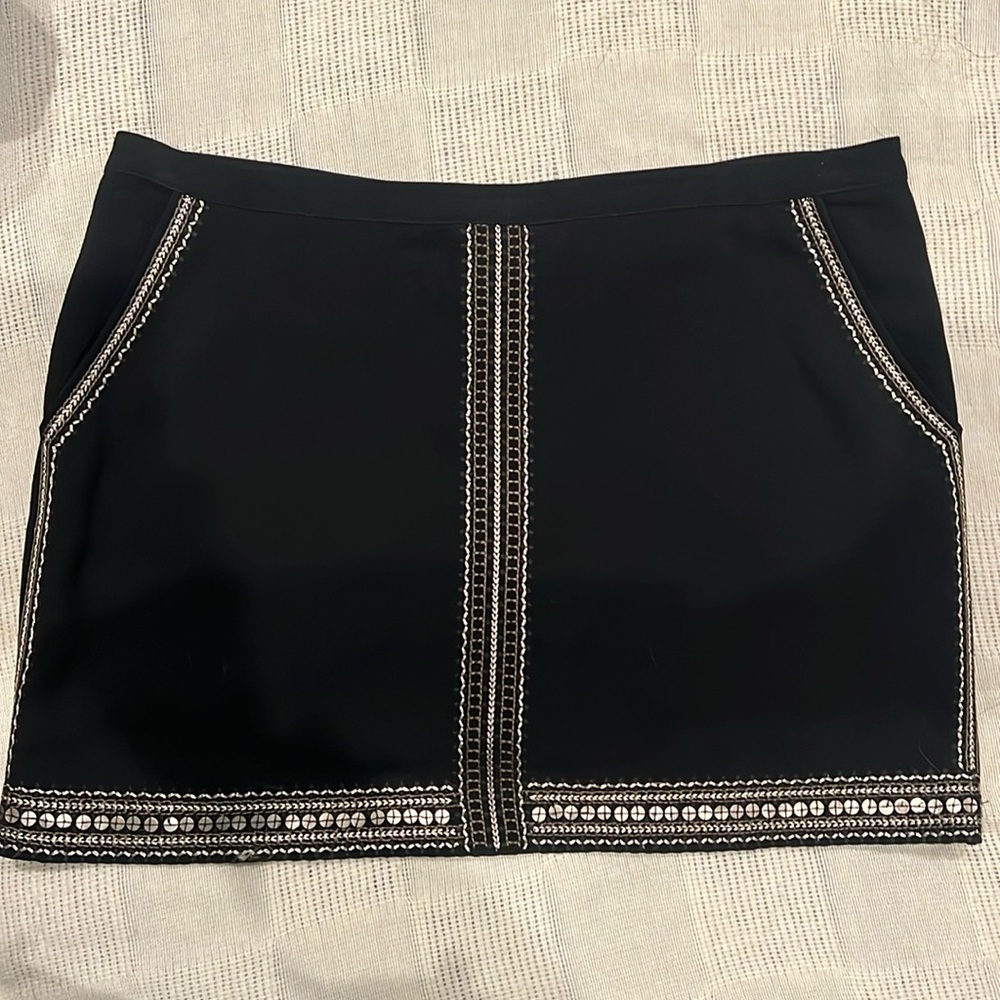 Black with gold detailing mini skirt. 15 1/2 inches in length.  Back zipper.